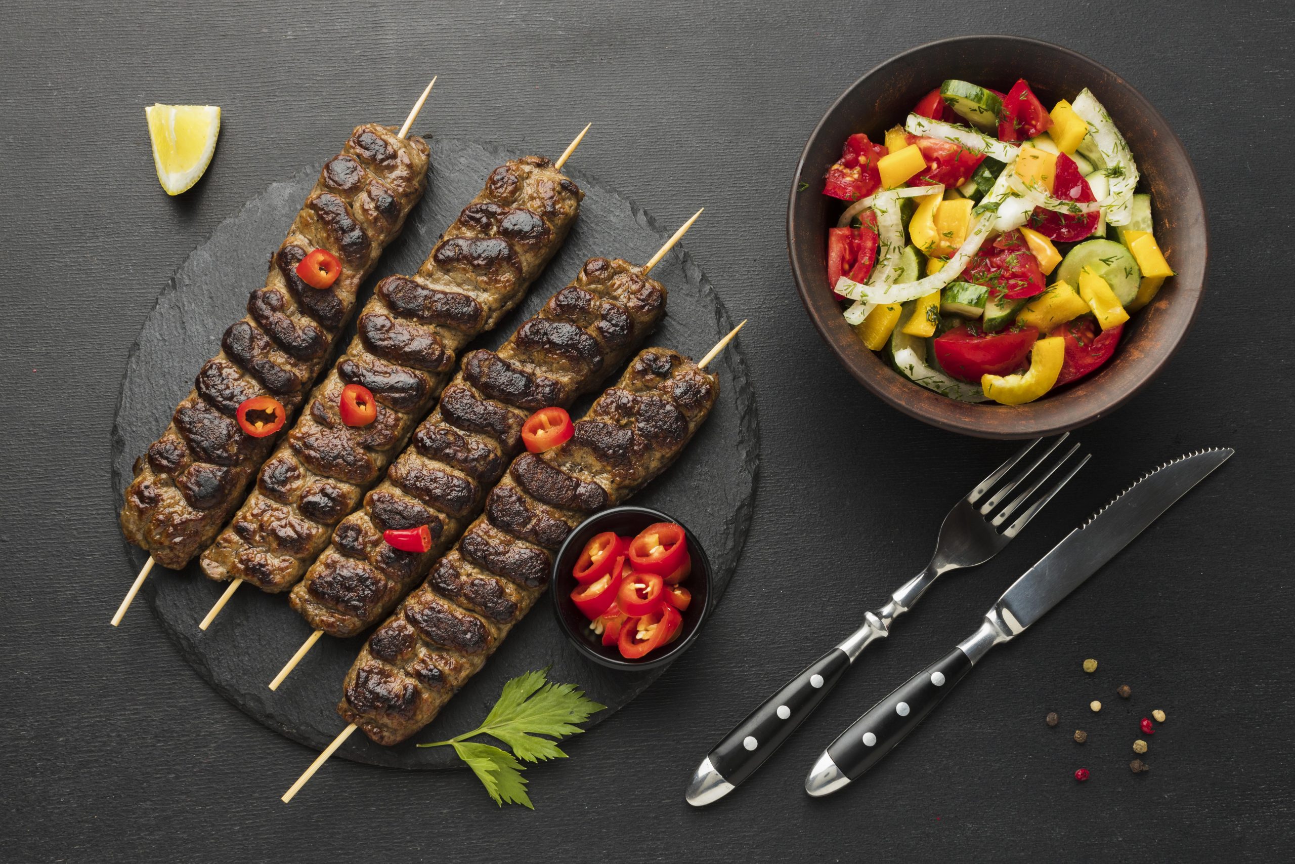 flat lay tasty kebab slate with other dish cutlery scaled Recipes
