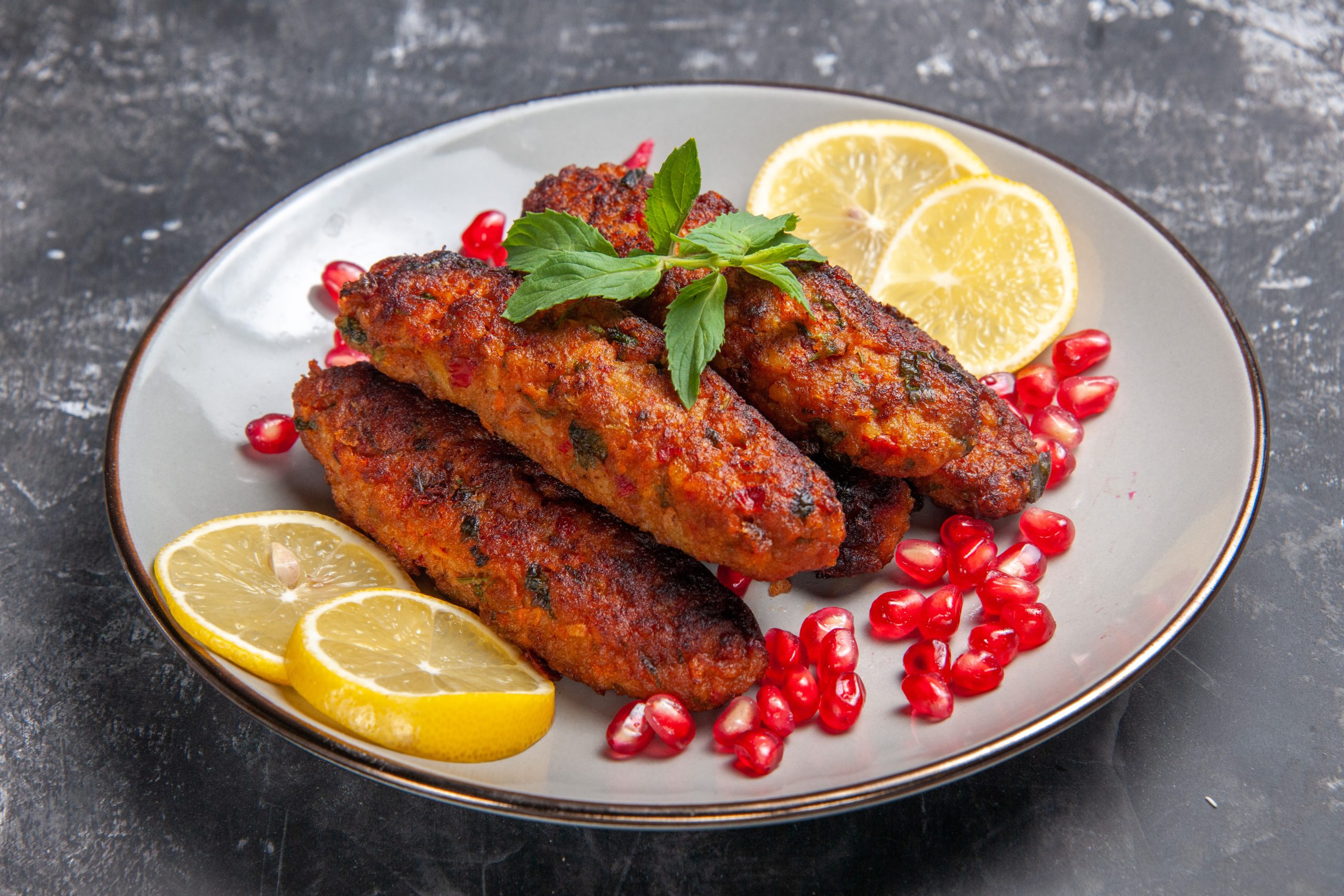 front view meat cutlets long formed with lemon slices 1 scaled Chicken Seekh Kebab